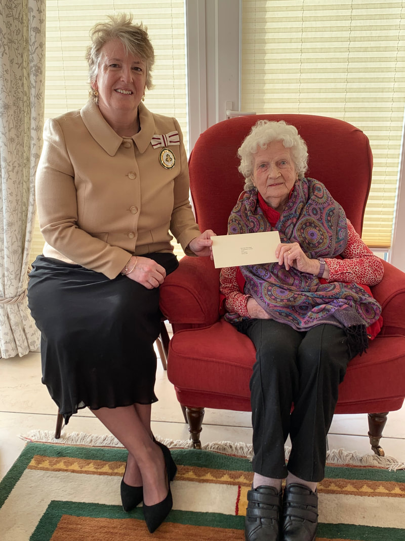 Mrs Julia Shirley, DL, presents Mrs McCullagh with her card